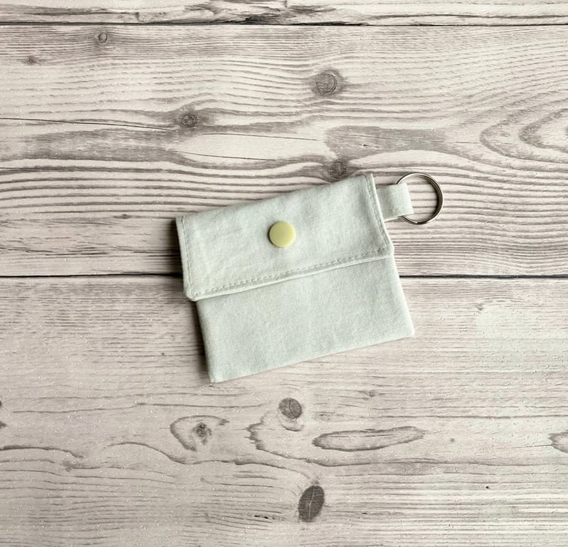 Plain light grey colour round lip balm keyring, keychain. Lipstick holder.