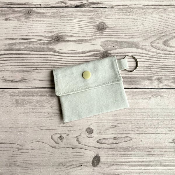 Plain light grey colour round lip balm keyring, keychain. Lipstick holder.