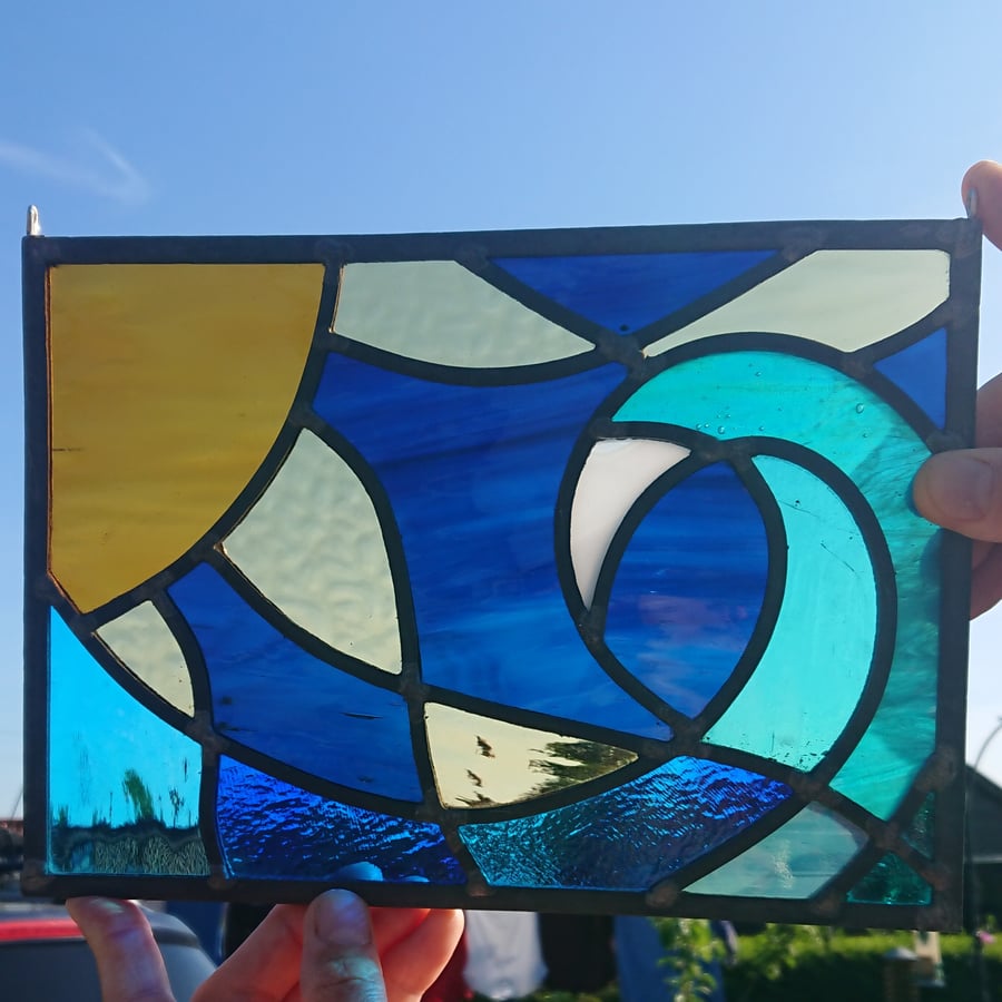 SOLD Stained glass leaded panel - amber sun, stormy sky and breaking wave