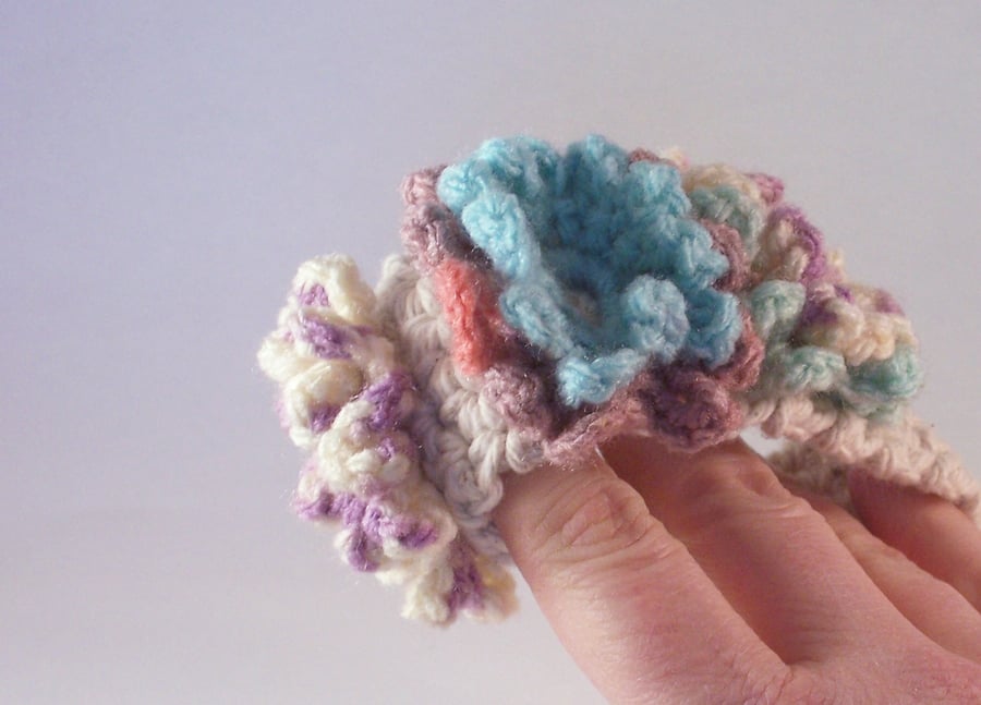 Crochet cuff with three flower blooms