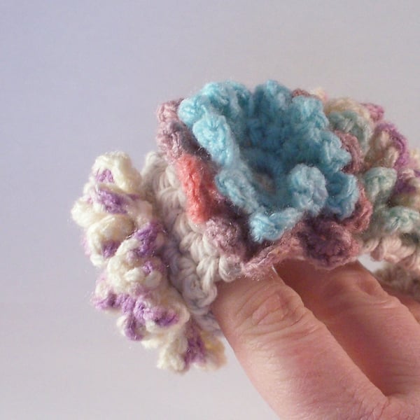 Crochet cuff with three flower blooms