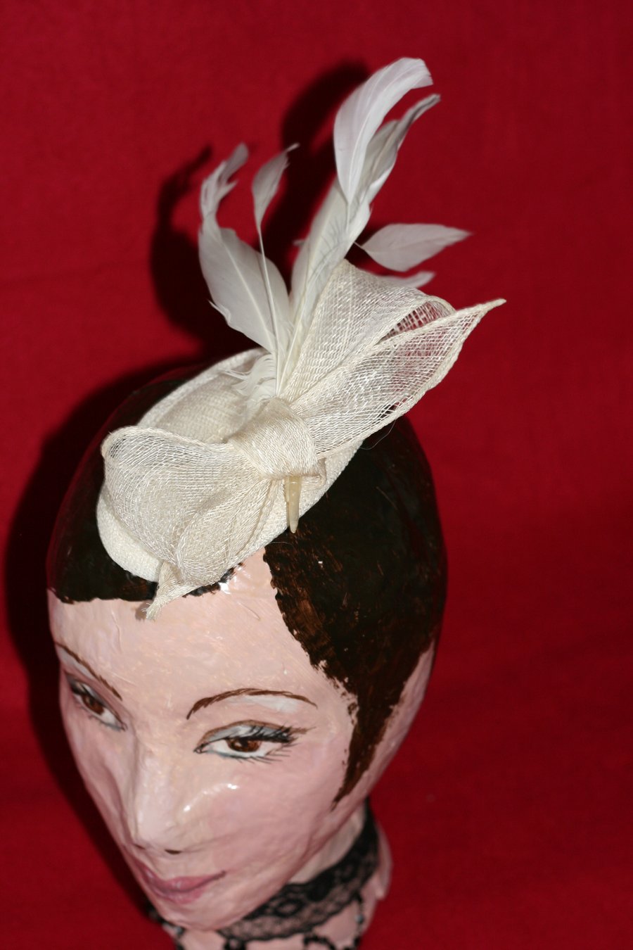 Straw ivory fascinator with bow and feathers