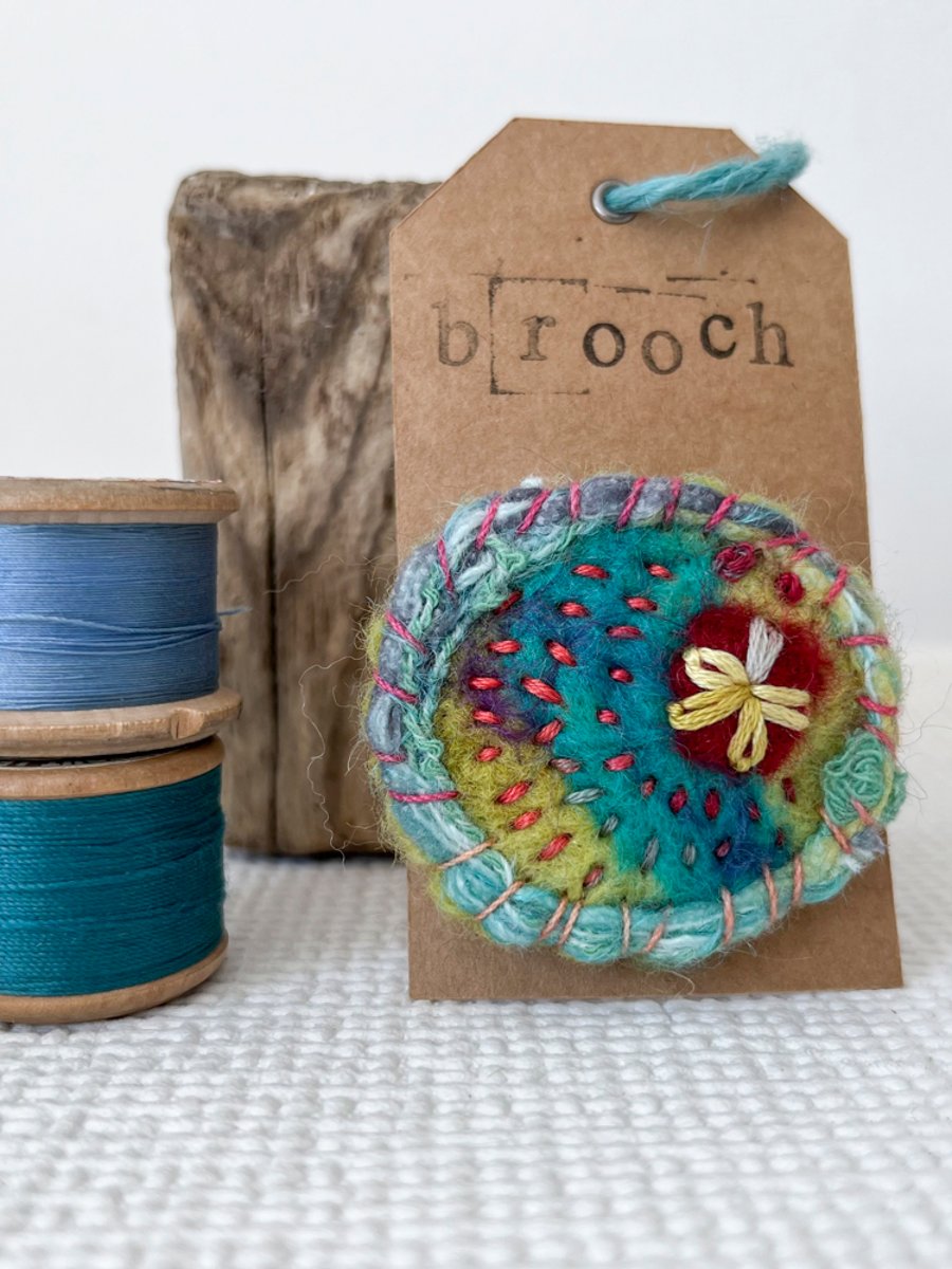 Needle felted hand embroidered circular brooch 