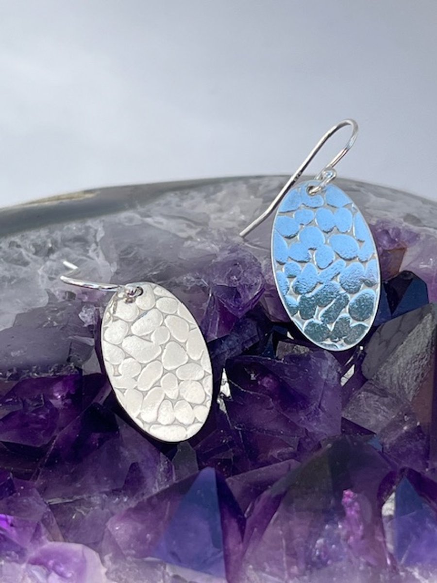 Oval silver earrings with pebble texture