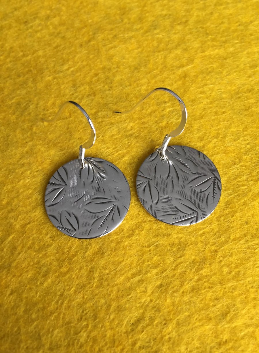 Silver disc earrings made from a cigarette case