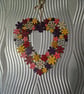 Flower wreath decorated with warm colours and embellished with sequins. - Image 1