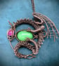Antique copper wire wrapped dragon pendant clutching an egg