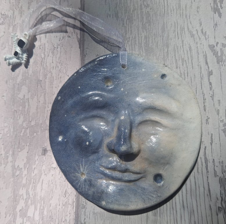 Man in the Moon with astronaut, hanging plaque