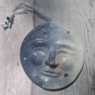 Man in the Moon with astronaut, hanging plaque