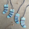 Set of four ceramic sock decorations .