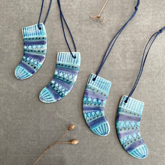 Set of four ceramic sock decorations .