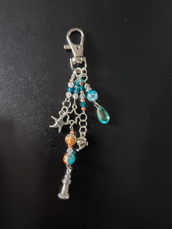 Nautical silver beaded bag charm with lighthouse, dolphin and dolphin charms