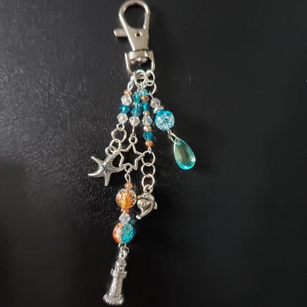 Nautical silver beaded bag charm with lighthouse, dolphin and dolphin charms
