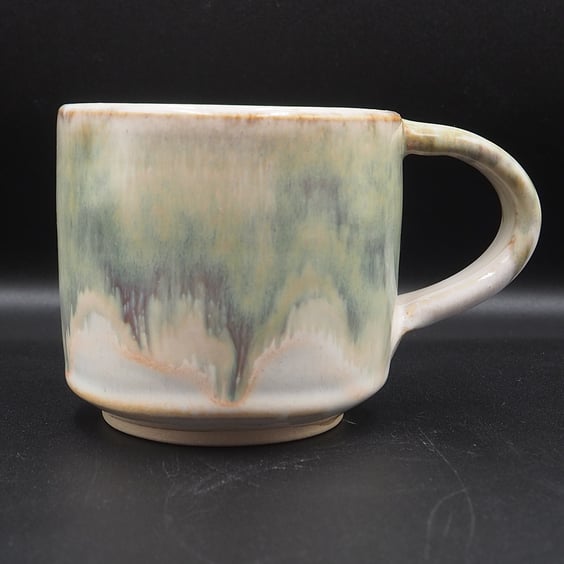 Large stoneware pottery mug finished in green, cream, white glaze.