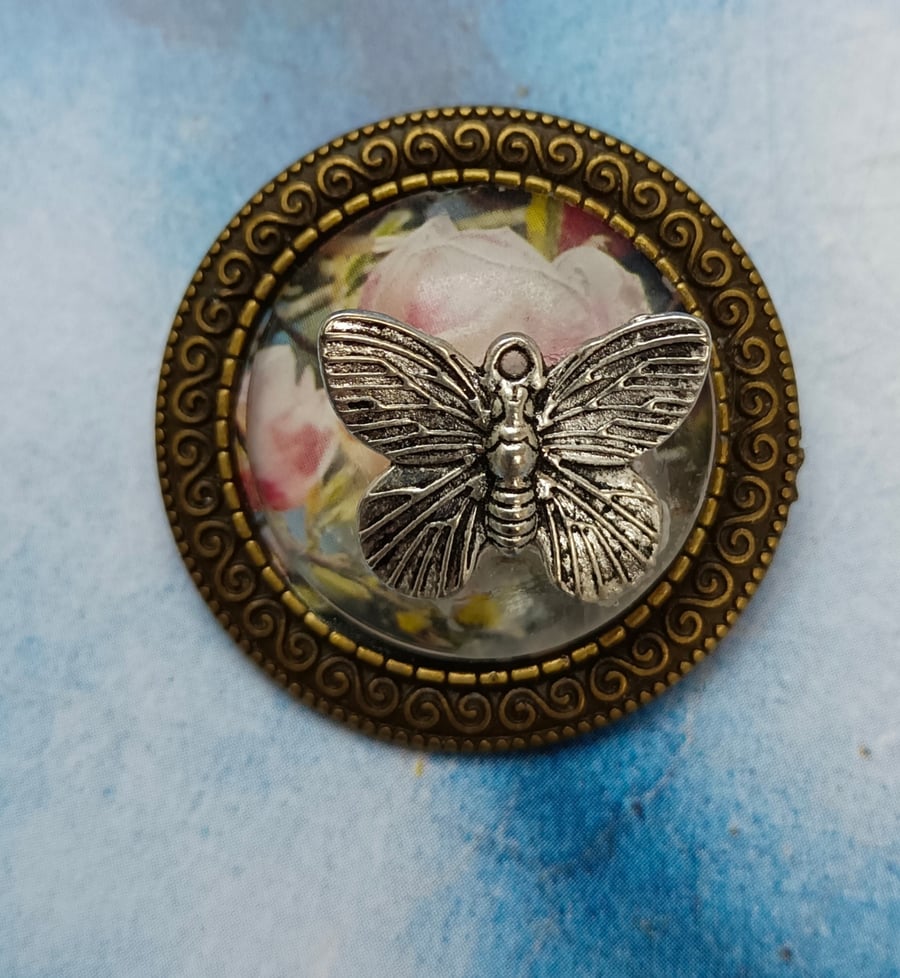 A Vintage Style Flower Brooch with a Silver Butterfly