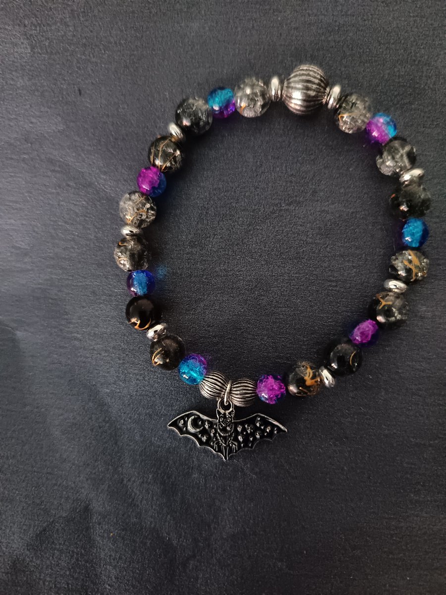 Elasticated beaded bracelet with black bat charm