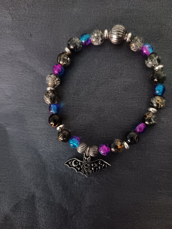 Elasticated beaded bracelet with black bat charm
