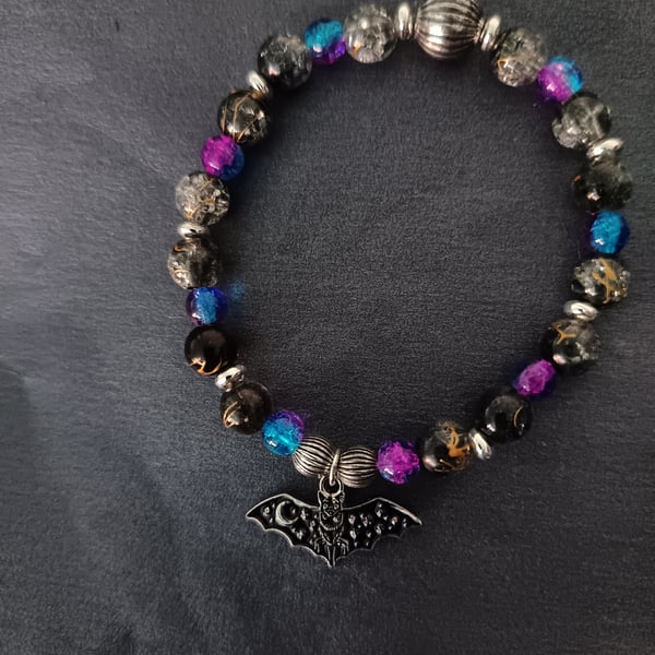 Elasticated beaded bracelet with black bat charm