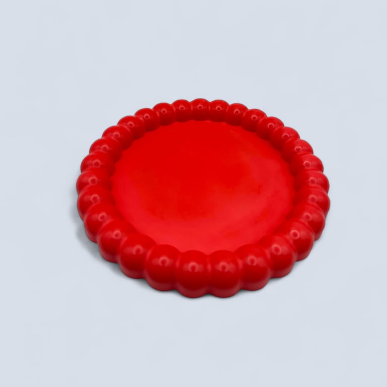 Round Red Decorative Tray With Raised Bubble Design on the Outer Edge