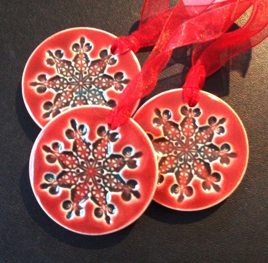 red ceramic snowflake decorations
