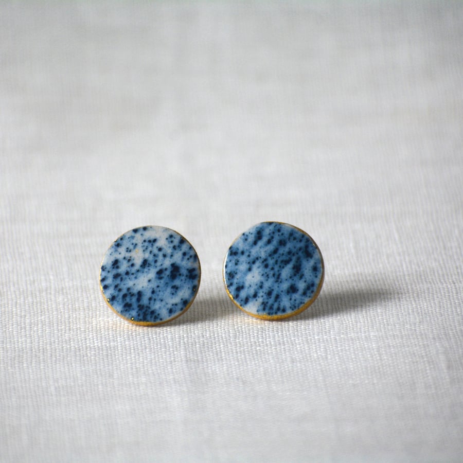 Porcelain earrings with blue stain detail and gold leaf around the edge