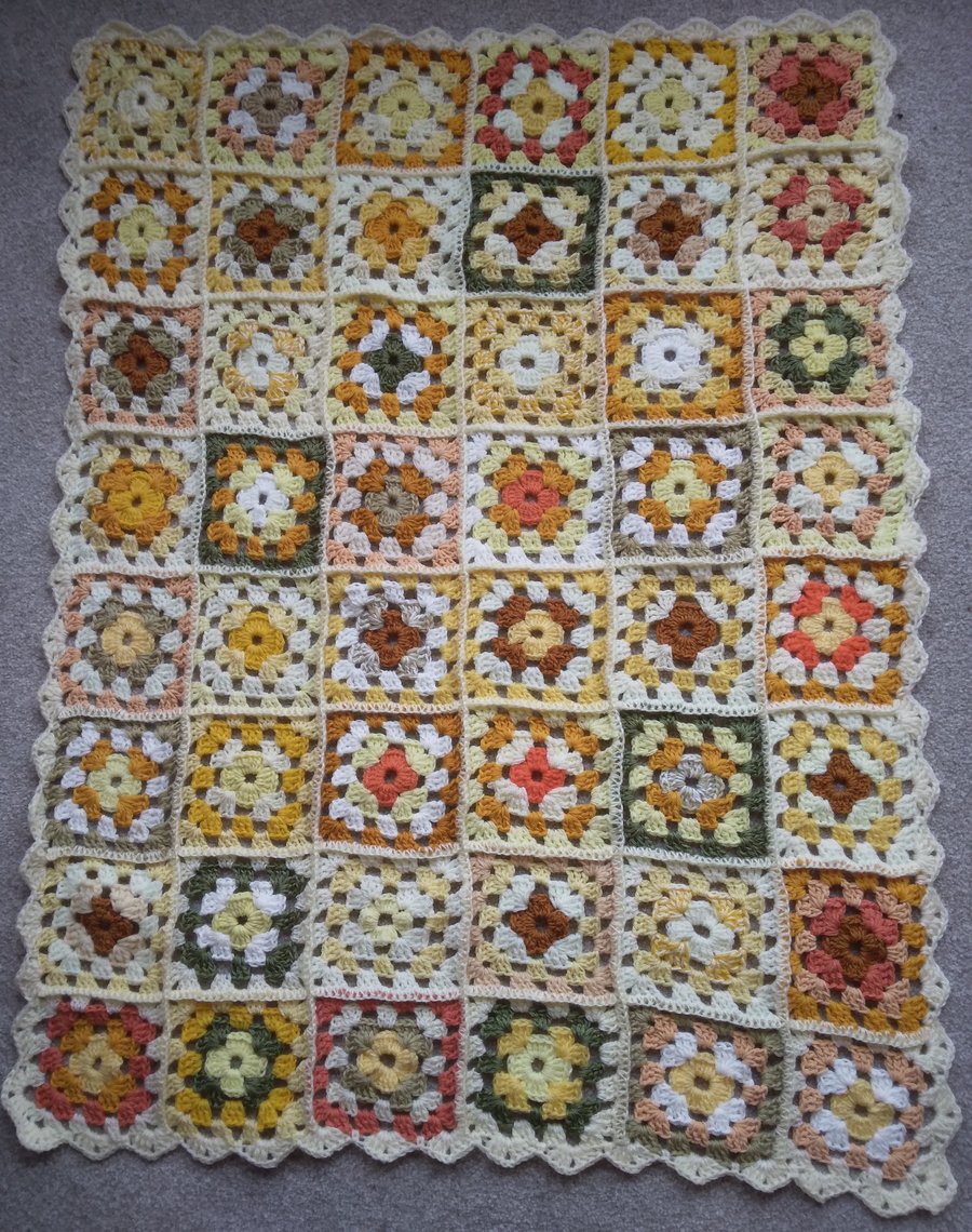Crochet granny squares blanket in shades of yellow. Handmade, unique.
