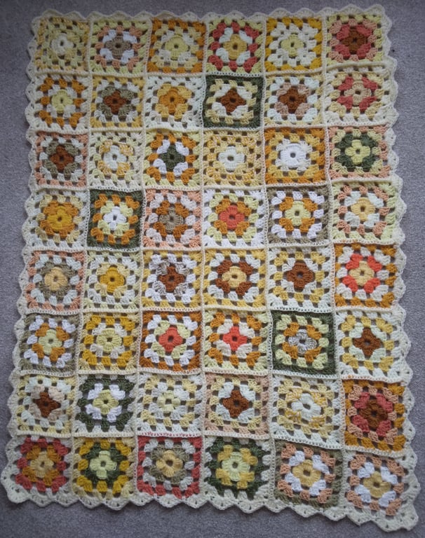 Crochet granny squares blanket in shades of yellow. Handmade, unique.