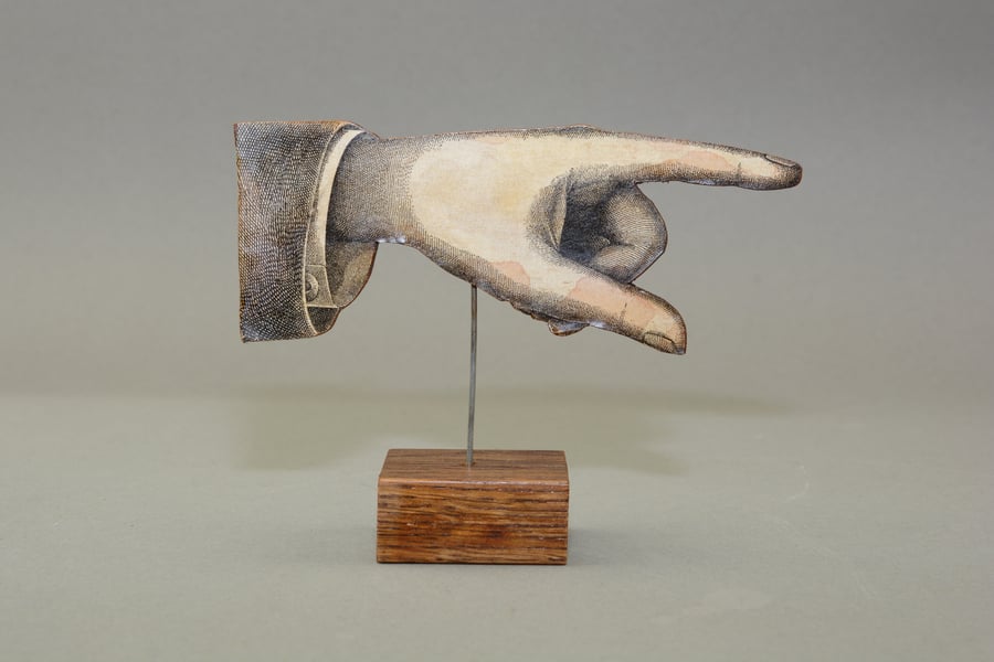 Pointing hand direction shop sign 