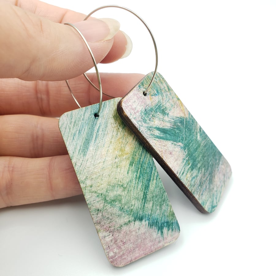 Rectangular shaped wooden earrings with a printed scribble effect design