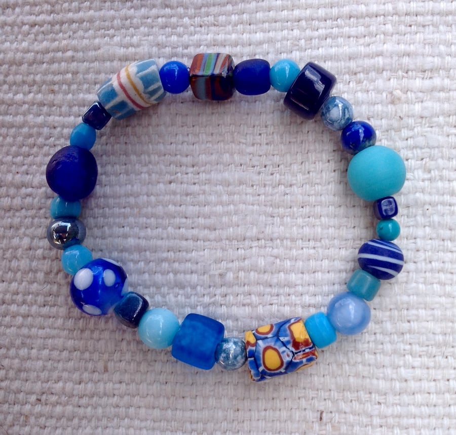 stretchy turquoise and blue bracelet with collection of unusual vintage beads
