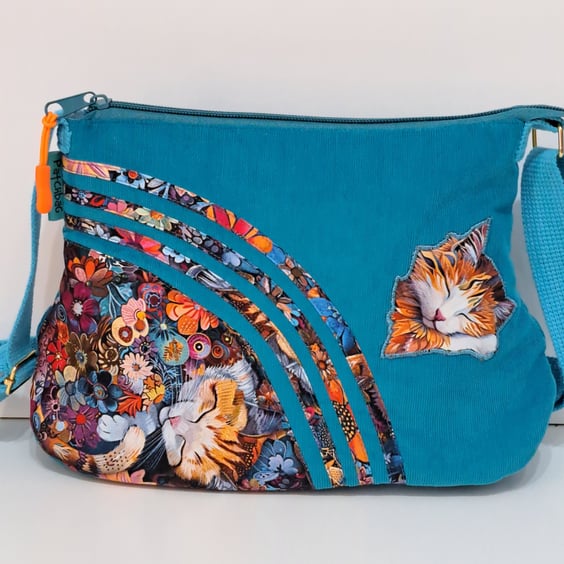 Blue handbag with sleeping cats and flowers 