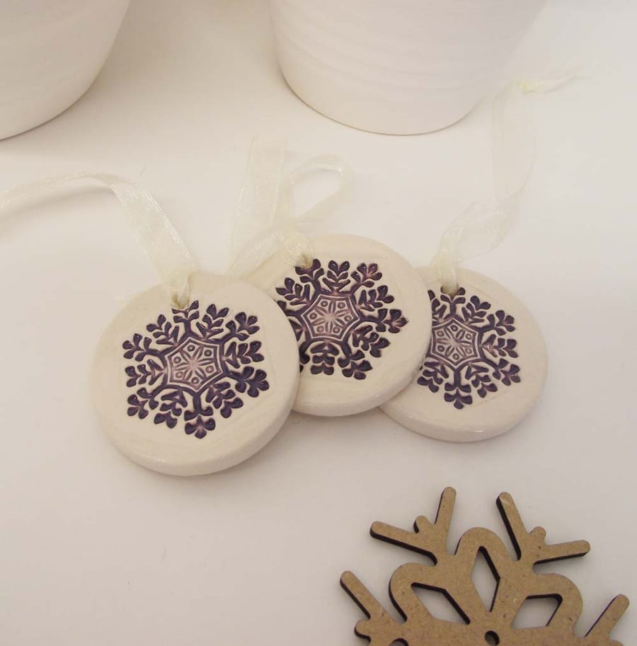 Set of three little purple snowflakes handmade ceramic decorations