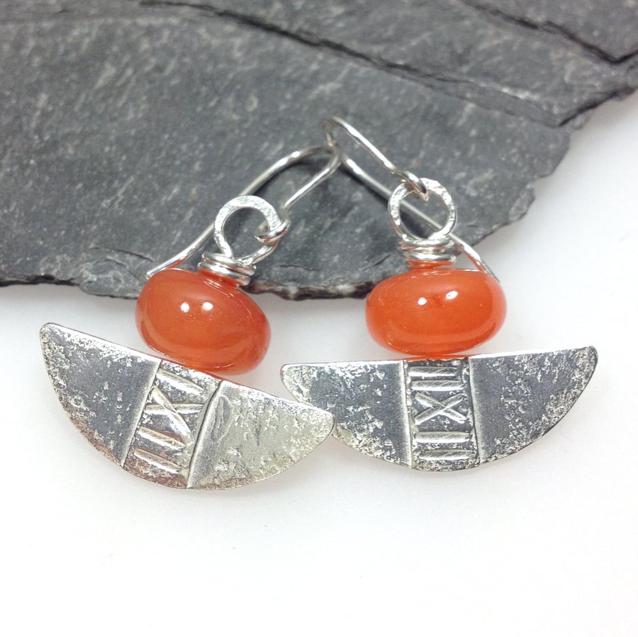 Silver and orange carnelian tribal blade earrings.
