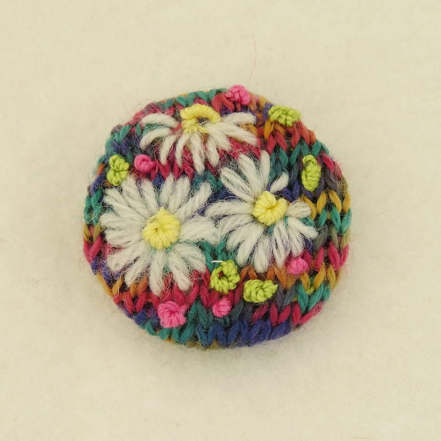 Daisy Brooch embroidered on knitted bright multi background