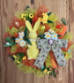 Yellow rabbit with yellow and orange deco mesh Easter door wreath