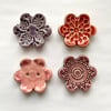 Set of four flower shaped ceramic handmade buttons