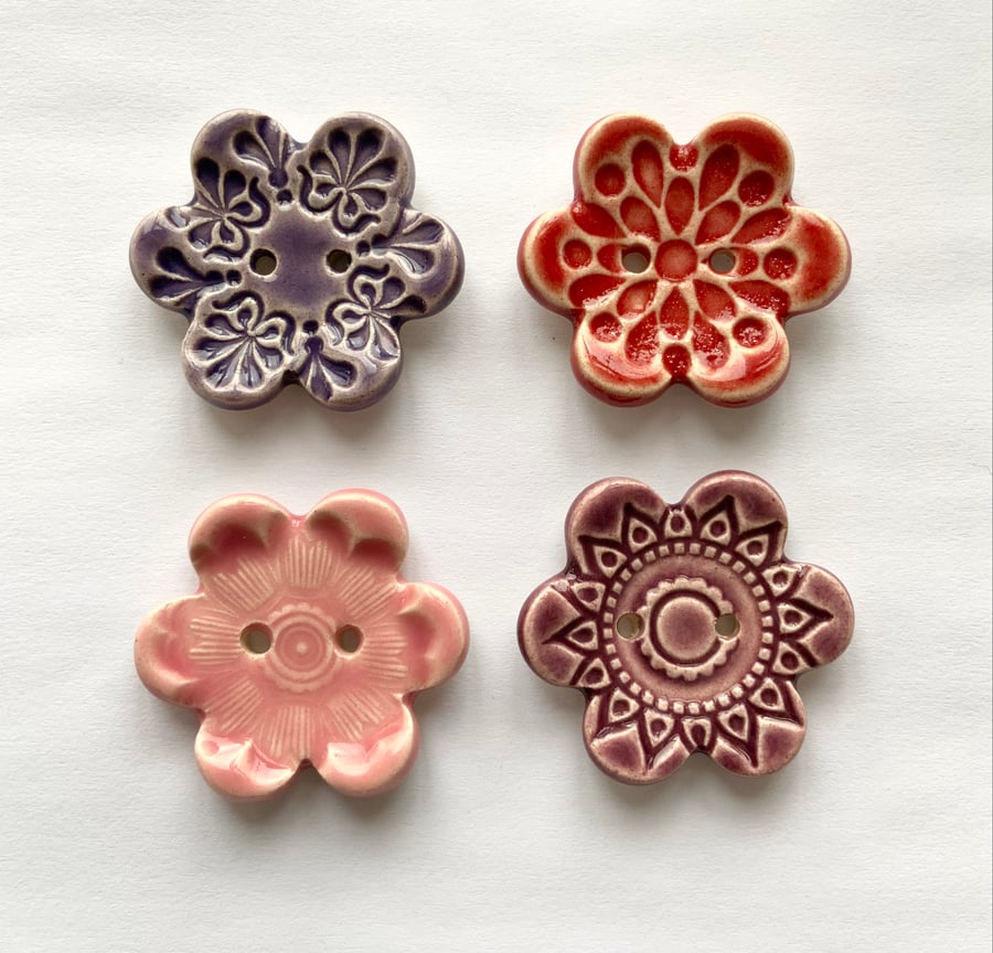 Set of four flower shaped ceramic handmade buttons