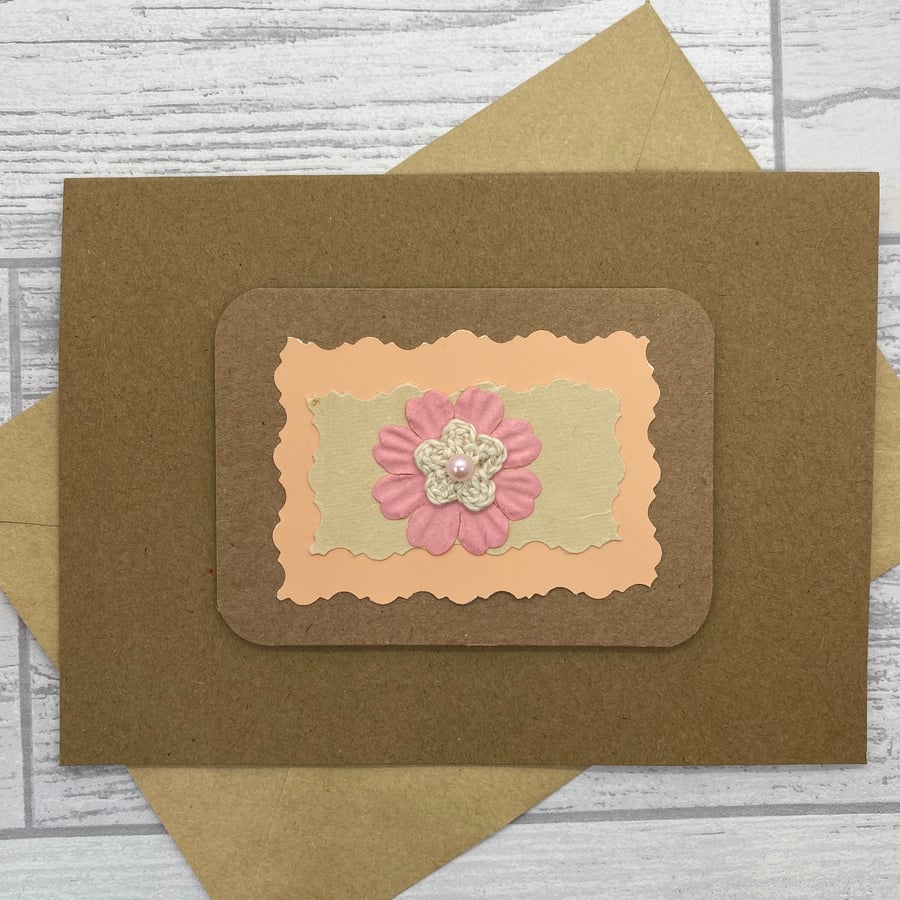 Blank greetings card with crochet flower