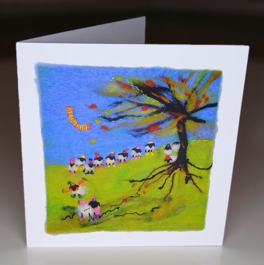 A greetings card with a  photograph of a children's felt art