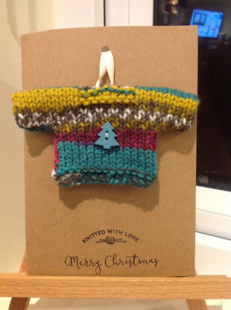 Handmade mini sweater attached to card with envelope.
