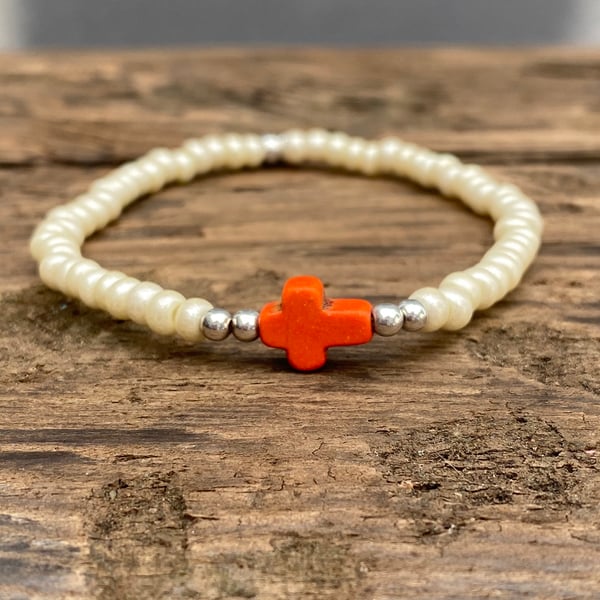 Orange howlite cross and cream seed bead bracelet 