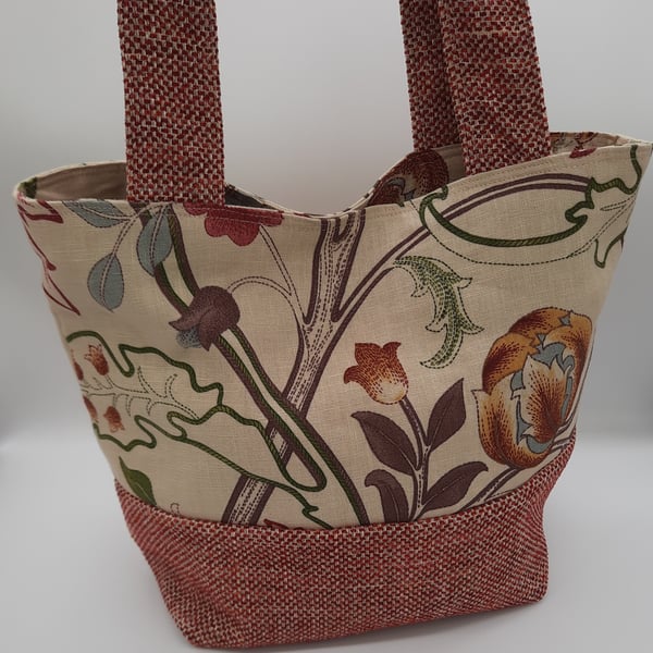 Red and beige floral fabric handbag.  