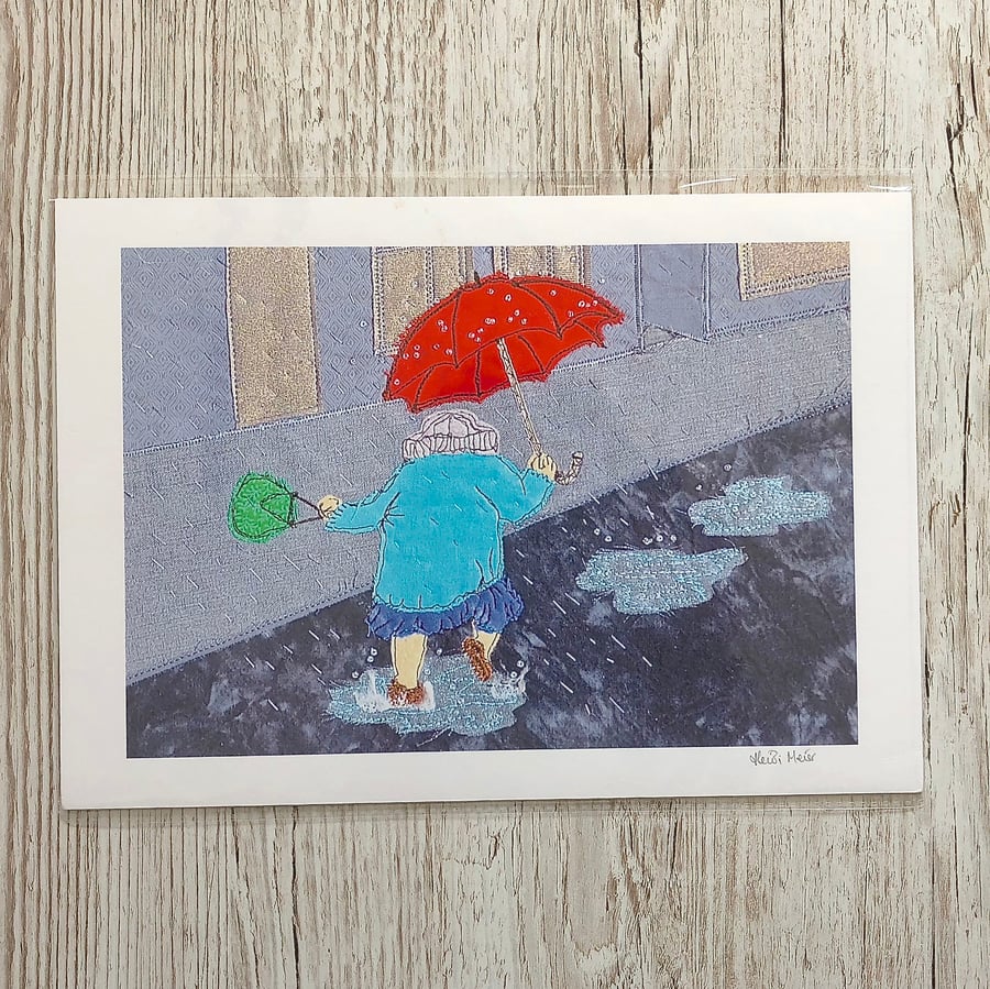 Fun picture of an old lady dancing in puddles in the rain with a red umbrella