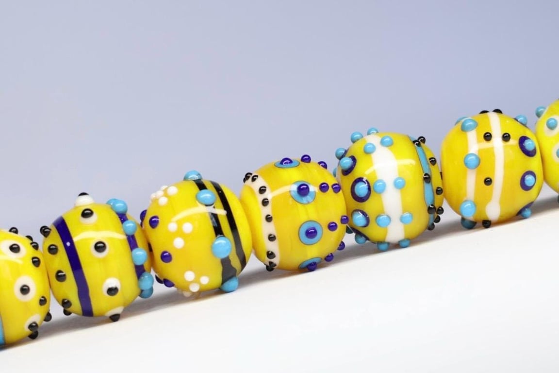 Handmade yellow, white and blue patterned lampwork glass beads