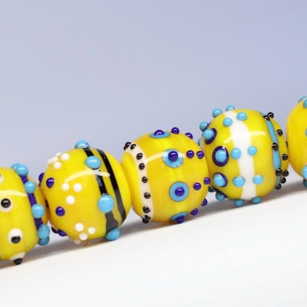 Handmade yellow, white and blue patterned lampwork glass beads