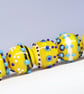 Handmade yellow, white and blue patterned lampwork glass beads