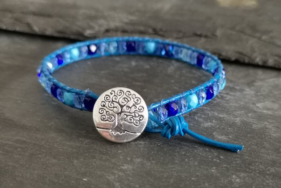 Leather bracelet with mixed blue faceted glass beads and decorative button