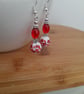 RED, WHITE AND SILVER CERAMIC BEAD EARRINGS. - Image 1