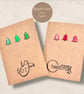A pair of rustic recycled Christmas cards with red and green tree embellishments