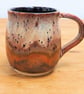 Large stoneware pottery mug finished in multi-coloured purple and copper glaze.